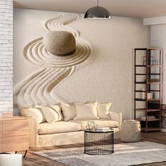 a living room filled with furniture and a large stone wall art work on the wall