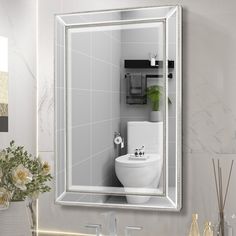 a bathroom with a sink, mirror and toilet in it's reflection on the wall