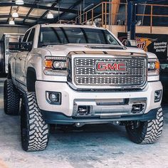 a white truck parked inside of a garage