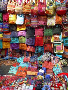 many bags and purses are on display for sale