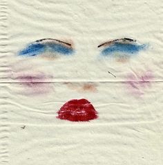 a drawing of a woman's face with blue and red lipstick