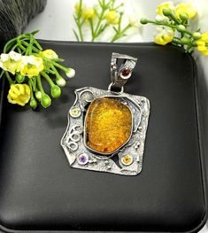 Artisan Amber gemstone pendant Hand-made Sterling Silver. Stones used: Amber, Peridot, Amethyst, Garnet, Citrine. Height - 51mm, Width - 34mm.Unique Handcrafted One-of a-kind Design PendantEach Piece of Jewelry in my Collection is Absolutely One of a Kind!When you start wearing a piece of my jewelry you will fall in love with it more and more each day and feel that good Energy and Love that I pass into it while creating this piece of Art.A piece of Art created for you to be inspired and love it Unique Multicolor Gemstones For Gift, Unique Multicolor Gemstones As Gifts, Handmade Amber Necklace For Anniversary, Fusion Style Pendant Jewelry As A Gift, Fusion Style Pendant Jewelry For Gifts, Yellow Jewelry With Artistic Design For Gifts, Fusion Style Pendant Jewelry Gift, Fusion Style Natural Gemstones For Gift, Handmade Fusion Style Necklaces For Gifts