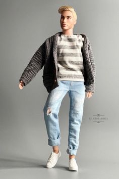 a doll with blonde hair is posed in jeans and a striped sweater, white sneakers