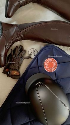 a pair of brown shoes sitting on top of a bed next to a computer mouse