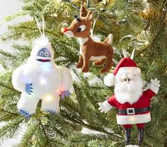 three christmas ornaments hanging from a tree in the shape of santa claus, snowman and rudolph