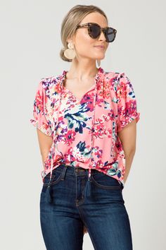 Carmen Flowers Top, Pink :: NEW ARRIVALS :: The Blue Door Boutique Pink Floral Print Split Neck Blouse, Pink Floral Print Blouse With Split Neck, Pink Split Neck Blouse With Floral Print, Casual Multicolor Tie Neck Tops, Spring Blouse With Tassel Ties And Short Sleeves, Casual Spring Tops With Tassel Ties, Spring Blouse With Short Sleeves And Tassel Ties, Casual Pink Tassel Top, Casual Pink Tops With Tassels