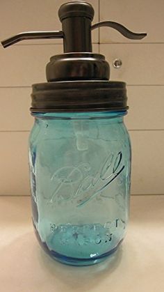 a mason jar with a soap dispenser attached to the top is sitting on a counter