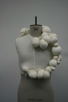 a mannequin with white beads on it's neck