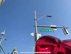 the street sign is clearly visible for all to see on this clear blue sky day