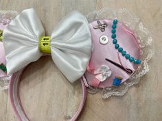 a minnie mouse ears with pearls and beads on it