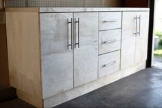 a kitchen cabinet with drawers and doors on the outside