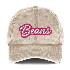 This Beans dad hat is comfortable, adjustable and is made just for you. It's a classic unstructured hat with the word "Beans" embroidered on the front in pink and white. This vintage-style dad hat was designed for bean lovers and comes in a variety of stylish faded colors. Wear this funny foodie hat as everyday wear or give it as a weird gift for a bean enthusiast. • 100% cotton twill • 6-panel unstructured cap • 6 sewn eyelets • Black sweatband • Metal snap buckle with an antique brass finish • Statement Hat, Funny Embroidery, Weird Vintage, Vintage Style Hat, Weird Gifts, Happy Design, Funny Outfits, Blue Embroidery, Embroidered Hats