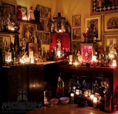 a room filled with candles and pictures on the wall