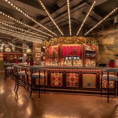 an elaborately decorated bar with stools and lights