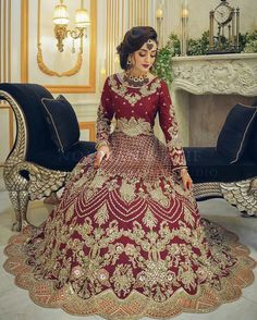 a woman in a red and gold wedding gown