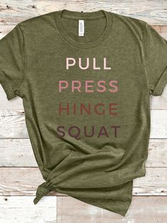 T-Shirt made specifically for women who lift weights Writing: "PUSH, PULL, HINGE, SQUAT" (AKA, the big 4) This classic unisex jersey short sleeve tee fits like a well-loved favorite. Soft cotton and quality print make users fall in love with it over and over again.  Bella Canvas Tee has a retail fit, so it falls and wears more naturally around your body, flowing with the curve of your chest, torso, and hips. The ribbed knit stitching on the collar looks stylish and also keeps the shirt looking f Green Relaxed Fit T-shirt For Workout, Workout Short Sleeve T-shirt, Green Graphic Tee For Workout, Comfortable Cotton Training T-shirt, Workout Crew Neck Tops With Screen Print, Graphic Tee Tops With Letter Print For Training, Athleisure Workout T-shirt With Screen Print, Crossfit Apparel, Crossfit Tshirts