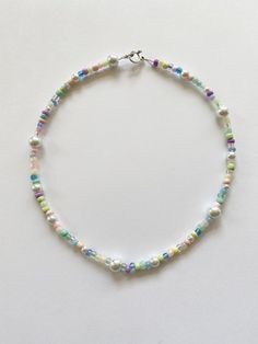 "️🍄 𝓰𝓾𝓶𝓭𝓻𝓸𝓹 𝓰𝓪𝓻𝓭𝓮𝓷 𝓷𝓮𝓬𝓴𝓵𝓪𝓬𝓮 ️🍄 FREE SHIPPING You will receive one necklace as seen in photos. Has a pastel rainbow and white color scheme. Made to order and beaded by me with luvvv <3 Strung on strong cord with a mixture of glass beads!! 🌹 Silver toggle clasp closure. Each necklace is unique with a different bead pattern but will look similar to photos. Looks great alone or layered with our mushroom garden necklace. Necklace variations - please choose when purchasing ( Adjustable Pastel Beaded Necklaces, Pastel Beaded Necklaces With Round Beads, Handmade Pastel Whimsical Jewelry, Whimsical Pastel Handmade Jewelry, Pastel Whimsical Handmade Jewelry, Pastel Jewelry With Colorful Beads In Playful Style, Cute Pastel Jewelry With Round Beads, Playful Pastel Jewelry With Colorful Beads, Cute Pastel Round Bead Jewelry