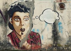 a painting on the side of a building with a thought bubble above it and a woman's face