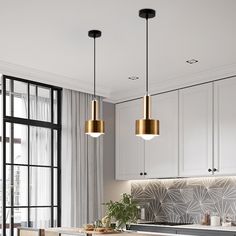 a kitchen with white cabinets and gold pendant lights hanging from the ceiling over the island