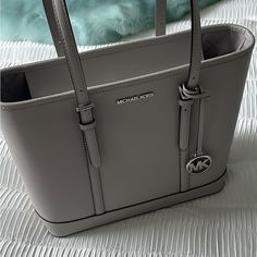 Brand New Michael Kors Jet Set Travel Small Grey Shoulder Tote Handbag! Never Worn, It Features Adjustable Shoulder Straps, Inner Zip And Slip Pockets, Mk Bag Charm And Jacquard Lining Tote Bag Saffiano Leather 100% Leather From Tanneries Meeting The Highest Standards Of Environmental Performance Gold-Tone Hardware 17”W X 11.5”H X 6.25”D Handle Drop: 11” Interior Details: Back Zip Pocket, 2 Front Slip Pockets Lining: 100% Polyester Zip Fastening Dust Bag Not Included Imported Style # 35f0gtvt9l Saffiano Leather Bag With Silver-tone Hardware For Shopping, Michael Kors Saffiano Leather Everyday Shoulder Bag, Michael Kors Saffiano Leather Shoulder Bag, Michael Kors Saffiano Leather Shoulder Bag For Shopping, Everyday Michael Kors Saffiano Leather Bag, Michael Kors Saffiano Leather Office Bag, Modern Michael Kors Saffiano Leather Bag, Mk Bags, Black Art Pictures