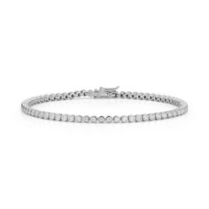 Our version of the classic diamond tennis bracelet, the Lulu Jack Bezel Tennis Bracelet dazzles with more than a quarter-carat of bezel-set round white diamonds going halfway around the bracelet. Perfect for everyday wear, this instant classic will look stunning with everything. The Lulu Jack Bezel Tennis Bracelet has slightly wider bezels than the Lulu Jack Single Row Bezel Bracelet. We suggest the Lulu Jack Single Row Bezel Bracelet if you're looking for a full eternity diamond tennis bracelet Dana Rebecca Designs, Bezel Bracelet, Diamond Tennis Bracelet, White Gold Bracelet, Tennis Necklace, Jewelry Show, Diamond Carat, Yellow Gold Bracelet, Tennis Bracelet Diamond