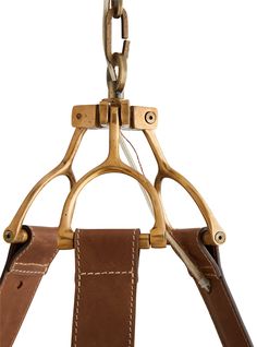 a pair of scissors are hanging on a leather holder with two handles and one handle