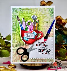 a close up of a card with scissors and crafting supplies on it's side