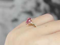 Truly all about the stone, this traditional, yellow gold mounting frames the stone perfectly while holding it securely with four split prongs. The center pops with an amazing pink color and is adorned with an expertly cut pink sapphire. Metal: 14K Yellow Gold Gem: Pink Sapphire 1.17 Carats Gem Measurements: 5 x 7.5 mm, Oval Ring Size: 5.75 Marks: "14" Stamped on the inside band Pink Ruby Ring In 14k Gold For Anniversary, Ruby Birthstone Ring With Pink Center Stone, Pink Birthstone Ring With Center Stone For Formal Occasions, Pink Birthstone Ring With Center Stone For Formal Events, Formal Pink Birthstone Ring With Center Stone, Pink 14k Gold Jewelry With Center Stone, Pink Birthstone Ring With Accent Stones For Formal Occasions, Pink Sapphire Birthstone Ring In Fine Jewelry Style, Pink Ruby Rings With Prong Setting