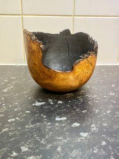 a wooden bowl sitting on top of a counter