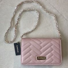 Bebe Sophia Crossbody Quilted Handbag with Chain Strap. Color: Blush. Crossbody strap with chain detail. Quilted design. 44.5” strap fully extended. Gold tone hardware. 1 interior zip pocket. 1 interior slip pocket. Chic Pink Wallet On Chain With Chain Strap, Pink Crossbody Evening Bag With Chain Strap, Pink Evening Wallet On Chain With Chain Strap, Chic Pink Clutch With Chain Strap, Chic Pink Evening Bag With Chain Strap, Rectangular Pink Wallet On Chain For Evening, Elegant Pink Wallet On Chain With Strap, Feminine Shoulder Bag With Chain Strap, Quilted Handbag