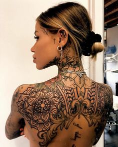 a woman with lots of tattoos on her back