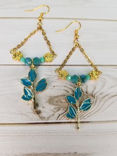 31x18mm enamel metal teal branch. 7x4mm flower spacer beads gold plated. 6&3mm Czech glass faceted rounds in teal. Gold plated chain and fishhook ear wires. Gold Czech Glass Dangle Flower Earrings, Gold Dangle Flower Earrings With Czech Glass, Gold Nickel-free Czech Glass Flower Earrings, Nickel-free Gold Czech Glass Flower Earrings, Nickel-free Gold Flower Earrings With Czech Glass, Nugget Necklace, Reno Nv, Jasper Necklace, Cool Necklaces