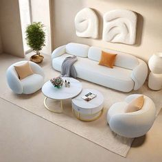 a modern living room with white furniture and orange pillows