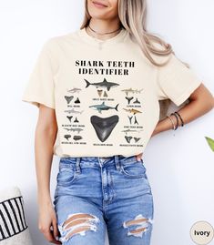 Discover our Shark Teeth Identifier Comfort Colors summer beach vacation shirt! This trendy Shark Tooth t-shirt is super soft and comfortable made of 100% ring-spun ethically grown cotton. It has a relaxed fit that is made of a medium fabric that is preshrunk. Looks super cute with shorts, jeans or size up 1-3 sizes for an oversized beach cover up. Great gift idea for a Shark tooth Lover! Comes in 14 pretty colors!  ♦️Please message me if you do not see the color shirt you would like♦️ 💠PRINT: This is a handmade, Direct-to-Garment printed item. The designs are professionally printed directly on to the shirt. All over printing is used. The ink is printed directly into the fabric. ✦Images may sometimes appear larger in the photo than in person due to images being a close up on the screen so Funny Short Sleeve T-shirt For Beach, Funny Cotton Tops For The Beach, Funny Beach T-shirt With Crew Neck, Funny Letter Print Tops For Vacation, Funny Beach T-shirt Short Sleeve, Funny Beach T-shirt With Print, Shark Shirts, Summer Beach Vacation, Shark Shirt