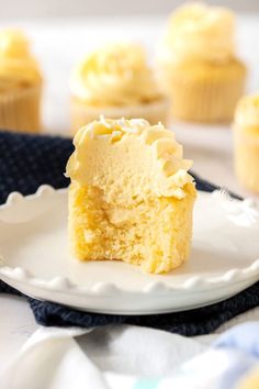 a close up of a cupcake on a plate with the rest of the cupcake in the background