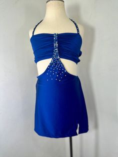 a blue dress with beading on the back and neckline, sitting on a mannequin