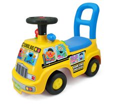 a yellow toy truck with sesame street characters on it's front and back wheels