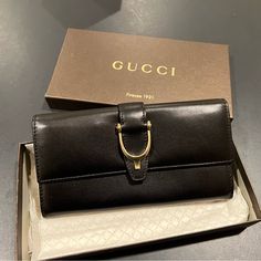 Gucci Wallet. Never Used. Button Clasp. Plenty Of Card Space. And Multiple Bill Compartments. Authentication Card Included. Designer Gucci Wallets For Business, Elegant Bifold Wallet For Office, Elegant Bifold Wallet With Gold-tone Hardware, Gucci Bifold Wallet For Formal Occasions, Classic Gucci Wallet For Evening, Designer Formal Wallets With Gold-tone Hardware, Classic Gucci Wallets With Gold-tone Hardware, Classic Gucci Wallet With Gold-tone Hardware, Gucci Black Wallet For Formal Occasion