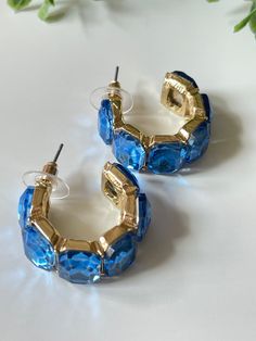 Elevate your style with Laura Hoop Earrings. The beautiful blue hoops and baguette shaped jewels give these earrings a unique and sophisticated look. The chunkier style provides a modern twist to a classic accessory, making it perfect for any occasion. Elevate your style with Laura Hoop Earrings. Perfect for Rush week for Sorority! Stud post Approx. 1" diameter Blue Metal Hoop Earrings, Blue Hoop Earrings For Party, Trendy Blue Crystal Earrings For Party, Trendy Blue Small Hoop Earrings, Trendy Small Blue Hoop Earrings, Modern Small Blue Hoop Earrings, Rush Week, Vintage Soul, Twist