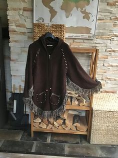 Vintage Knitted Brown Fringed Cape Hooded Zipper Front Poncho  Fabric: 80% Acrylic 20% Wool Vintage condition very good. Fits like Size S-M-L Please rely on measurements. Measurements (lying flat): Length with Fringe: 36 1/4"/ 92cm. Length without Fringe: 32 1/4"/ 82cm. Sleeve + Shoulder with Fringe: 28 3/4"/ 73cm. Sleeve + Shoulder without Fringe: 24 3/4"/ 63cm. Bust: 24"/ 61cm.( Please see photo 6) Please double check measurements to insure a proper fit. Please  note that color may slightly va Brown Knit Winter Poncho, Winter Brown Knit Poncho, Brown Knit Poncho For Winter, Hooded Wool Poncho For Fall, Cozy Brown Long Sleeve Cape, Fringe Cape, Ladies Poncho, Vintage Knitting, Latvia