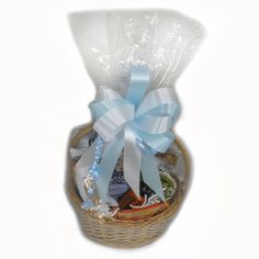 a basket filled with lots of different types of food and candy in blue ribbon tied around it