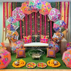 an elaborately decorated stage with colorful umbrellas and decorations