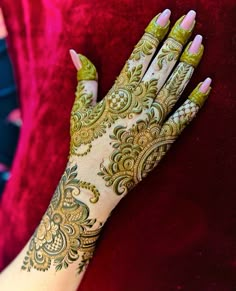 a woman's hand with henna on it