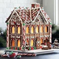 a gingerbread house with candy canes on the table