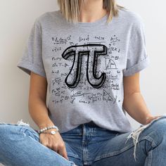 a woman sitting on the floor wearing a pi shirt