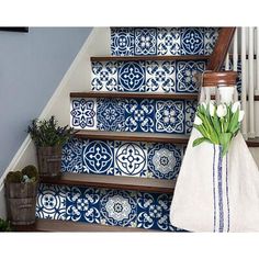 the stairs are decorated with colorful tiles and flowers