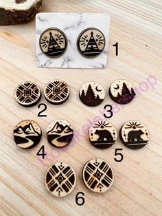 the wooden buttons have different designs on them and numbers are shown in front of it