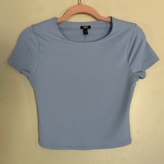 Women's Express Dusk Blue Body Contour Matte 90's Cropped Tee. Crew Neck. Short Sleeves. Double Layer Of Fabric In Front And Back. Straight Hem. Cropped Length. Brand New With Tags Size: Small Basic Cropped Tee, Light Blue Stretch Crew Neck Top, Light Blue Stretch Short Sleeve Tops, Trendy Fitted Blue Crop Top, Blue Fitted Short Sleeve Top With Crew Neck, Blue Fitted Crew Neck Short Sleeve Top, Light Blue Fitted Crew Neck Tops, Blue Fitted T-shirt With Short Sleeves, Light Blue Fitted T-shirt For Summer