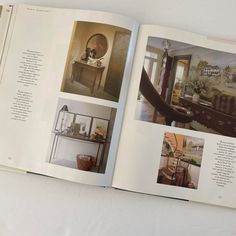 an open book with pictures of furniture and decor on the pages, including a mirror