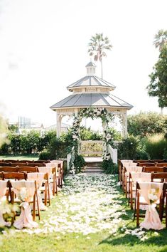 an outdoor ceremony set up with chairs and flowers